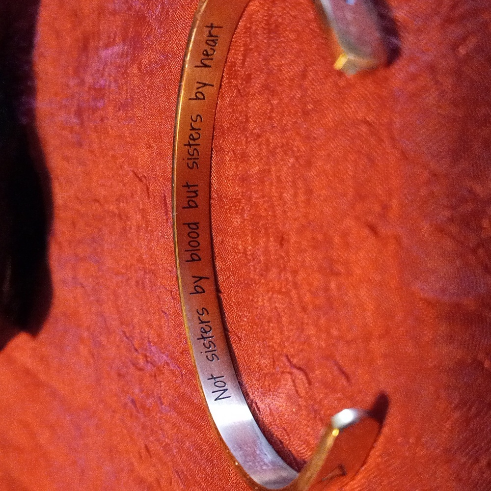 Gold tone bracelet. Not sister by blood but sisters by heart